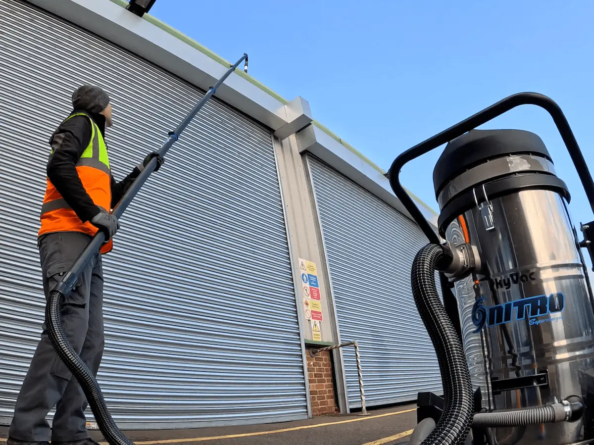 Man Using Gutter Vacuum On Commercial Building In Cornwall With Gutter Vaccum Min 2